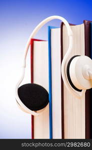 Concept of audio books with earphones on white