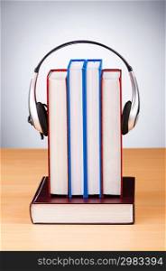 Concept of audio books with earphones on white