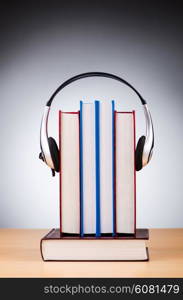 Concept of audio books with earphones on white