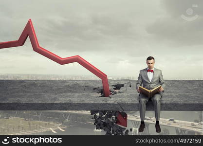 Concept of business collapse. Businessman and red decreasing arrow breaking through floor