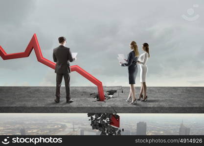 Concept of business collapse. Businesspeople and red decreasing arrow breaking through floor