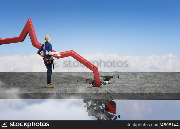 Concept of business collapse. Repair woman and red decreasing arrow breaking through floor