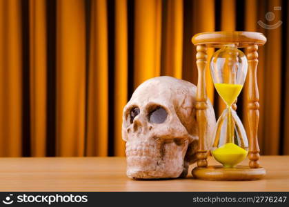 Concept of death with hourglass and skull