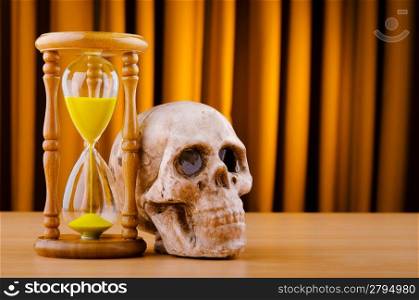 Concept of death with hourglass and skull