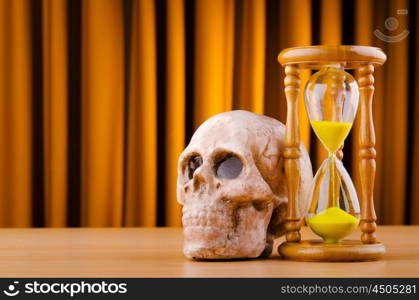 Concept of death with hourglass and skull