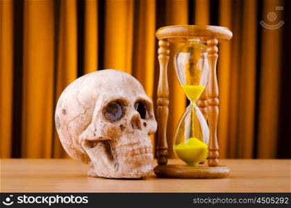 Concept of death with hourglass and skull