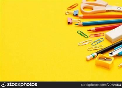 Concept of education top view notebooks and accessories stationery in the library at school yellow background