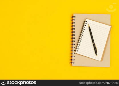 Concept of education top view notebooks and stationery accessories stationery in the library at school yellow background