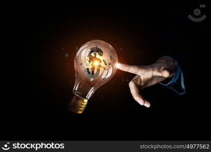 Concept of electric energy. Close up of human hands touching with finger light bulb