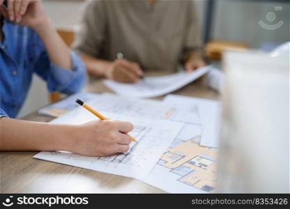 Concept of engineering consulting, Two female engineers discuss and sketches blueprint of building.