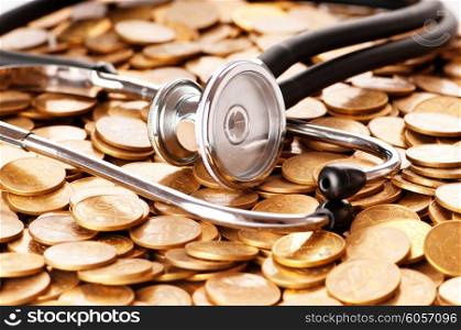 Concept of expensive healthcare with coins and stethoscope