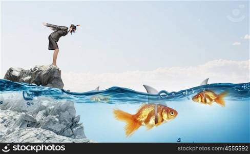 Concept of fake threat when businesswoman jump in water with shark appear to be goldfish . False risk for your business