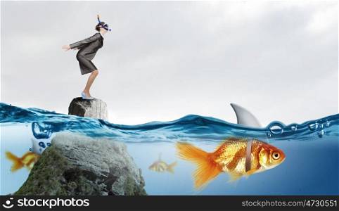 Concept of fake threat when businesswoman jump in water with shark appear to be goldfish . False risk for your business