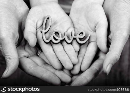 concept of family values - hands holding word love