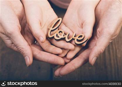 concept of family values - hands holding word love