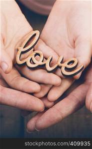 concept of family values - hands holding word love