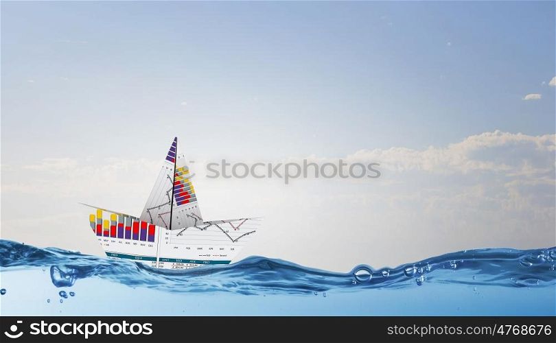 Concept of financial security. Paper boat with graphs and diagrams floating on water