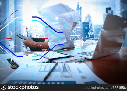 Concept of focus on target with digital diagram.designer hand working and smart phone and laptop on wooden desk in office with london city background