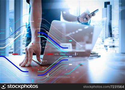 Concept of focus on target with digital diagram.designer hand working and smart phone and laptop on wooden desk in office with london city background