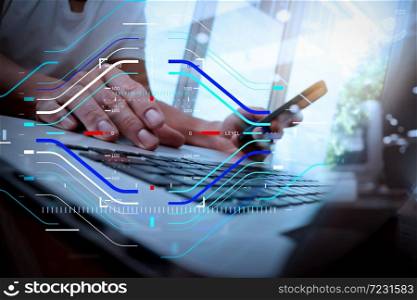 Concept of focus on target with digital diagram.designer hand working and smart phone and laptop on wooden desk in office with london city background