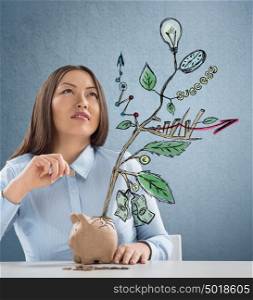 Concept of Growing company with sketch of a plant with business symbols and businesswoman putting coin in piggybank
