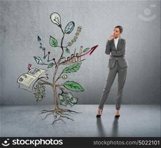Concept of Growing company with sketch of a plant with business symbols and businesswoman standing near
