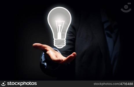 Concept of idea or creativity. Close up of businessman holding symbol of light bulb