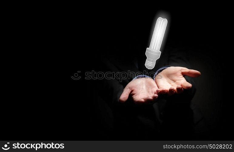 Concept of idea or creativity. Close up of businessman holding symbol of light bulb