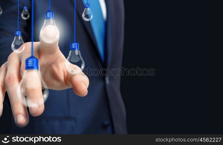 Concept of idea or creativity. Close up of businessman touching with finger virtual light bulb