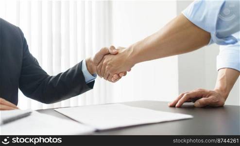 Concept of lawyer counseling, Businessman and senior lawyer shake hands after negotiating deal.