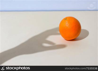 Concept of Male hand picks up an orange
