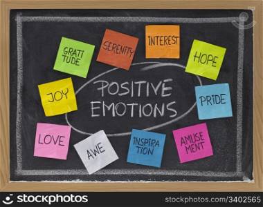 concept of positive emotions - color sticky notes and white chalk handwriting on blackboard