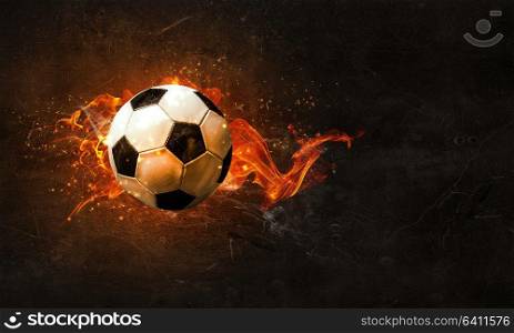 Concept of soccer game with ball in fire flames. Mixed media. Soccer Ball on Fire