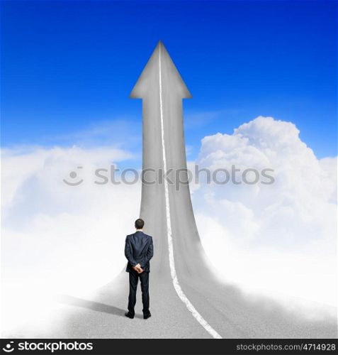 Concept of the road to success. Concept of the road to success with a businessman standing on the road
