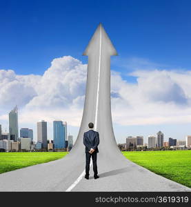 Concept of the road to success with a businessman standing on the road