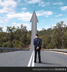 Concept of the road to success with a businessman standing on the road