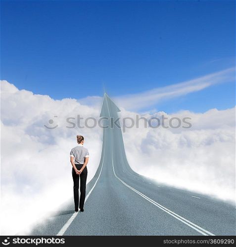 Concept of the road to success with a businesswoman standing on the road