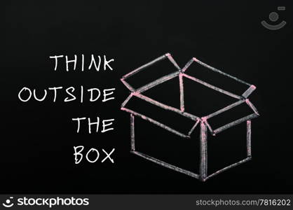 "Concept of "Think outside the box" drawn with chalk on a blackboard "