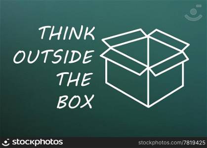 "Concept of "Think Outside the box" drawn with chalk on a green chalkboard "