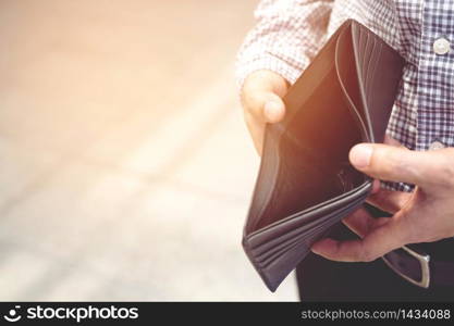 Concept of unemployed. Asian businessman is opening empty wallet.