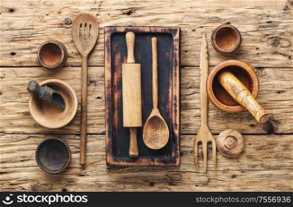Concept of wooden rustic kitchenware utensils set on old background. Set of wooden cooking utensils