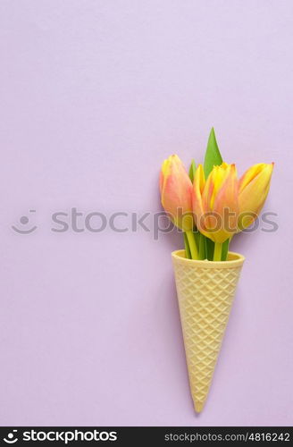 Concept with tulips in wafer ice cream cone