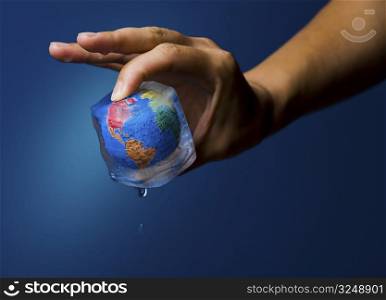 Conceptual image about saving Earth. The globe frozen into an icecube thrawing.