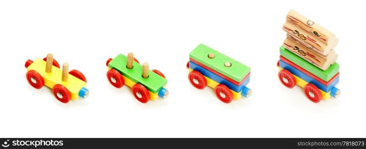 Conceptual image of a production situation in various stages of its capacity, represented by a toy train carriage, being loaded with blocks