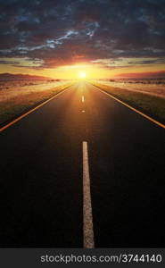 Conceptual image of a straight asphalt road leading into the light