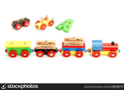 Conceptual image of a value chain, represented by a neatly organized toy train, with various obsolete carriages and bricks - the process steps and procedures - in the background