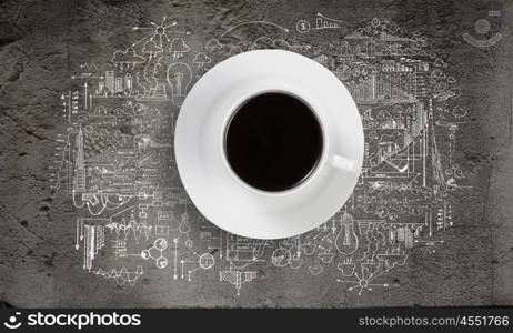 Conceptual image of cup of coffee with business sketches at background