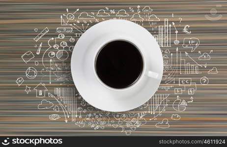 Conceptual image of cup of coffee with business sketches at background