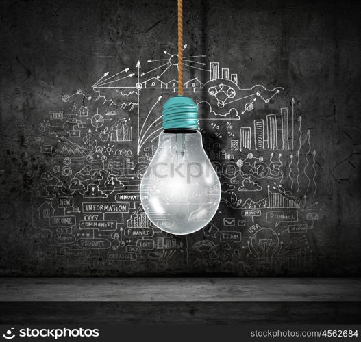 Conceptual image of light bulb on wall with sketches of ideas. Brigth ideas