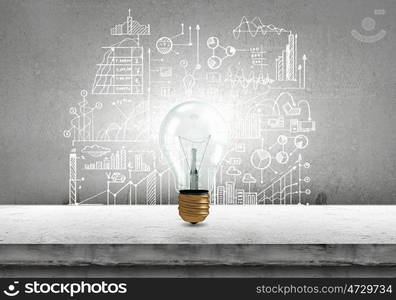 Conceptual image of light bulb on wall with sketches of ideas. Brigth ideas